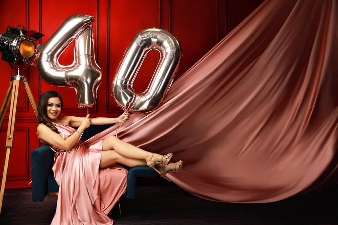 Flying dress — pink gown, red backdrop, balloons