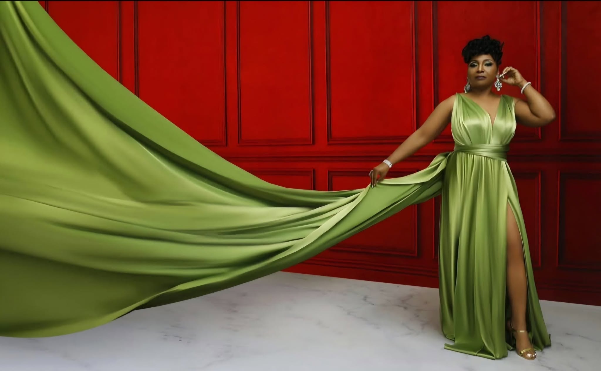 Flying dress — green gown, red paneled backdrop