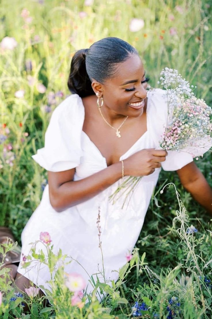 Krissy — white dress, wildflower field, holding bouquet, laughing